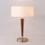The Pasadena Table Lamp is a modern table lamp with a weathered brass steel body and base, complemented by a white linen...