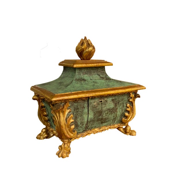 Of bombe form, on paw feet with carved leaves in corner and pagoda form top. Flame finial. Door locked, no key. 19th century.