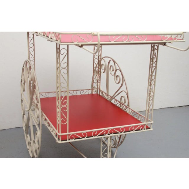 French garden serving trolley. Construction made of curved metal, painted white. Inserts made of red Formica coated...