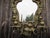 A 19th century heavy gilt brass mirror with five branch candelabra, the central foliate pediment flanked by scrolled leaf...