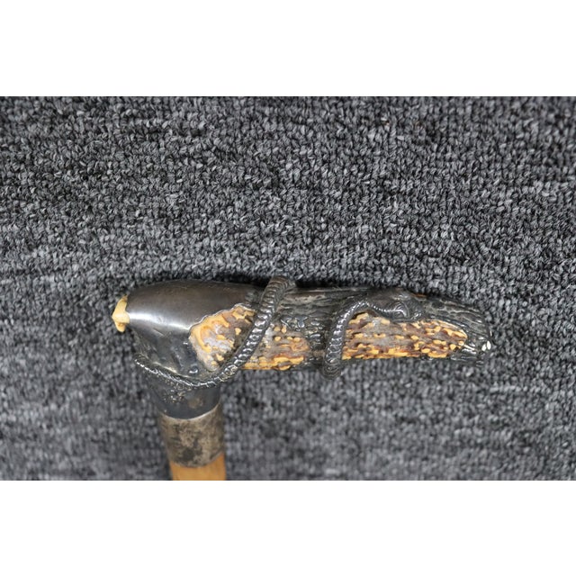 Antique walking stick featuring a naturally formed walnut shaft with a distinctive handle incorporating deer antler and a...