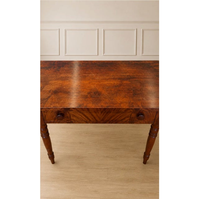 Elegant curves meet practical utility. Crafted from premium walnut wood, this vintage demi-lune writing desk functions...