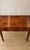 Elegant curves meet practical utility. Crafted from premium walnut wood, this vintage demi-lune writing desk functions...