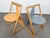 A pair of postmodern triangle shaped chairs in different color finishes and with a sleightly different backrest. Probably...
