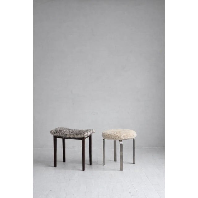 a sculptural chrome stool upholstered in plush lambswool. compact yet substantial, this piece works equally well as extra...