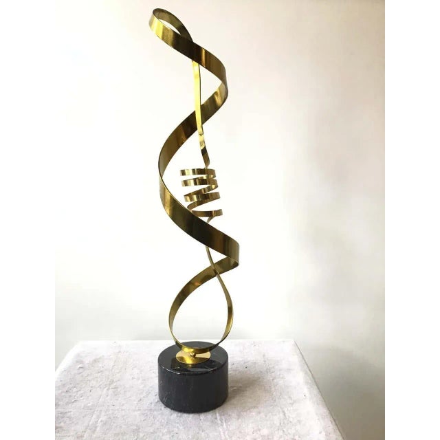 1980s brass ribbon abstract sculpture on marble base Brass sculpture can turn on base.