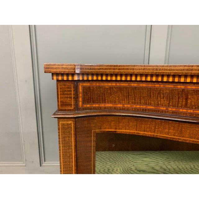 A charming Edwardian period inlaid mahogany display cabinet. Of serpentine form and very well constructed in solid...