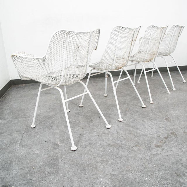 Set of 4 of Russell Woodard Sculptura mesh outdoor chairs, circa 1950. No major wear or breaks in the mesh throughout....