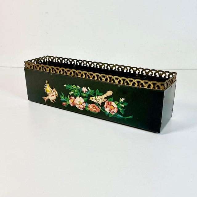 This is a pretty hand painted metal Tole Planter Box. It’s from the 1970s and features birds and flora botanicals on the...