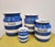An assembled collection of four blue and white banded striped Cornish Ware kitchen storage jars. The blue and white stripe...