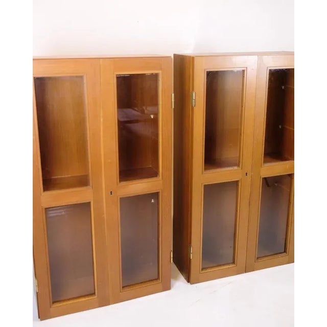 Set of two display cabinets in Oregon pine from the 1960s. Danish design with glass doors and fixed shelves. Elegant and...