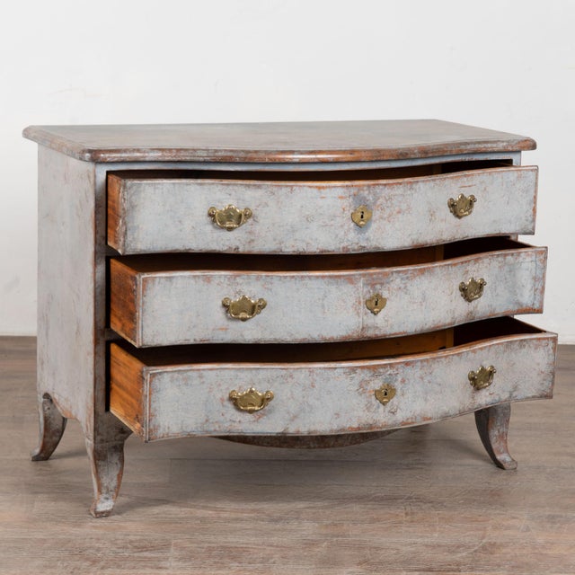 Late 18th century Swedish Rococo chest of three drawers crafted in pine. The chest features a newer professionally applied...
