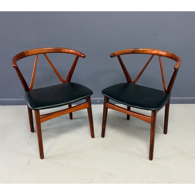 Dining chair from Henning Kjaernulf, produced by Bruno Hansen. Constructed in rosewood, with a black leather seat and a...