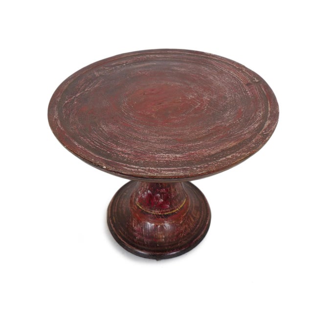 Antique Javanese offering stand handcrafted from hardwood and finished in richly weathered red lacquer with traces of...
