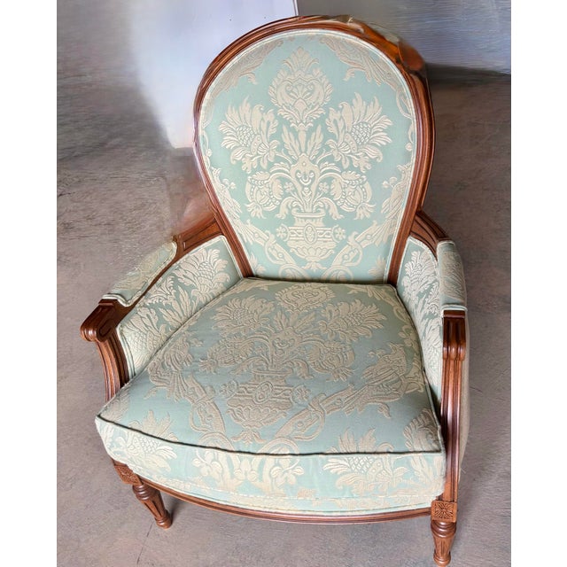 This chair displays a classic Louis XVI style, as evident in its elegant lines, oval backrest, and carved details on the...
