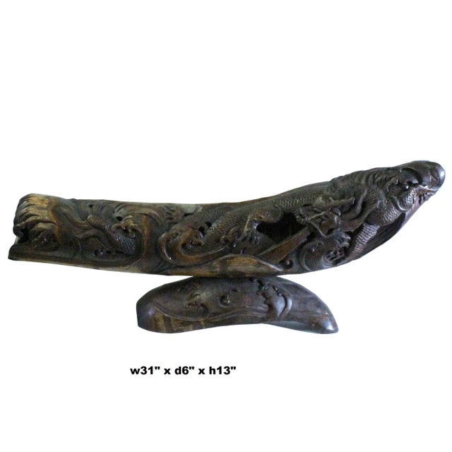 This is a collectible and decorative oriental dragon figure carved from a natural bamboo plant. It is in a curved column...