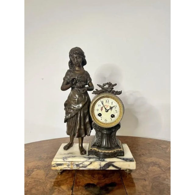 Outstanding quality antique Victorian clock garniture, with spelter figure decoration having a figure of a girl holding a...
