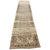 An elegant antique runner with a beautifully faded palette and an intricate geometric design. The warm beige field is...