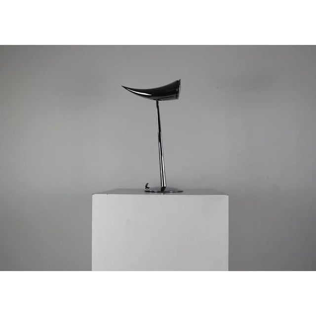 Ara table or desk lamp in polished chrome provides direct illumination. The head adjusts to direct lighting at a 90-degree...