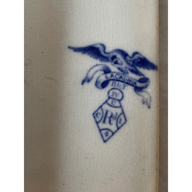 This stunning platter is shaped octagonal with trellis border. The center is decorated with a classical statue near a...