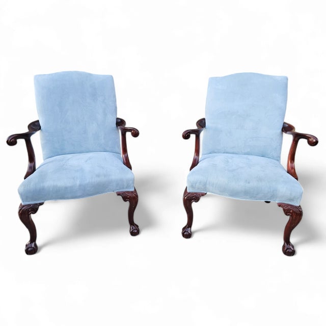 This pair of Vintage Mahogany and Suede Gainsborough Armchairs is a stunning complement to any high-end décor and a...