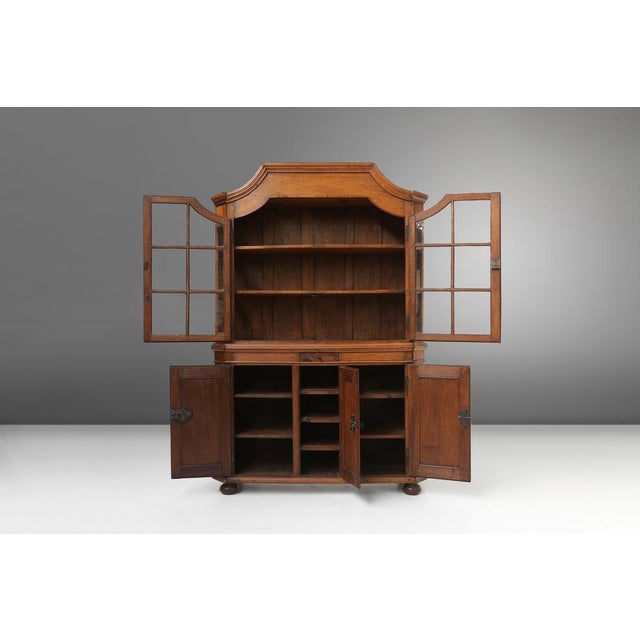 Authentic 18th-century German display cabinet, a masterpiece of craftsmanship and design. Made of solid oak, this cabinet...