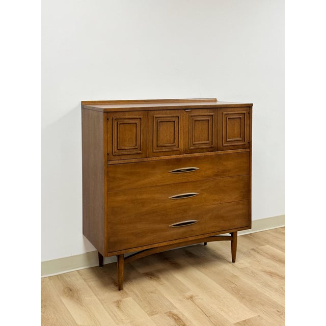 This striking vintage Broyhill Premier Sculptra gentleman's tallboy chest is a highly collectible and sought after mid-...