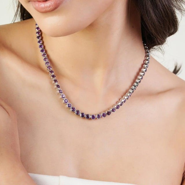 Crafted in fine 925 sterling silver, this elegant natural amethyst link necklace showcases a timeless continuous line...