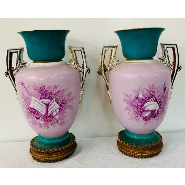 A gorgeous pair of late 20th century French vases or urn in the manner of Sèvres. The vases are beautifully hand painted...