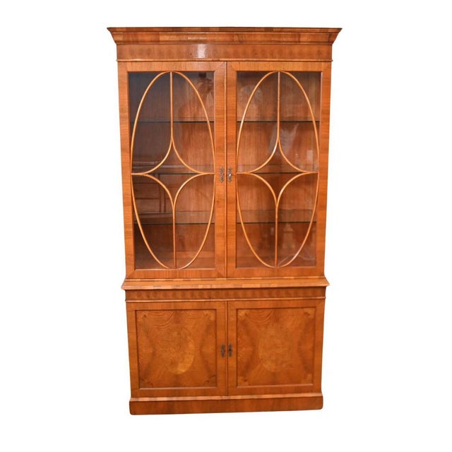 Elegant Georgian style burr walnut library bookcase Ideal for books or china Top half features the glass covered section...