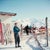 Mountain Top by Toni Frissell A skier checks their skis at a mountain top terrace, Klosters, Switzerland, 1951. (Photo by...