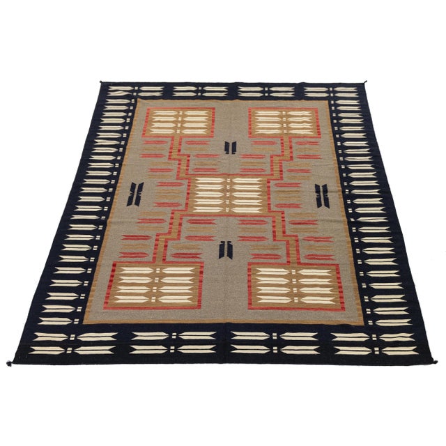 This striking handmade wool rug masterfully blends traditional Diné (Navajo) design elements with a clean, modern...