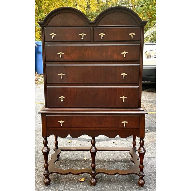 This vintage highboy dresser combines timeless craftsmanship with elegant design. The standout arched crown top and turned...