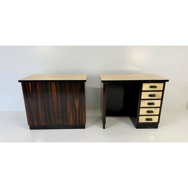 Elegant pair of Italian Art Deco twin desks, 1940s. The refined design features Macassar wood structures enriched with...