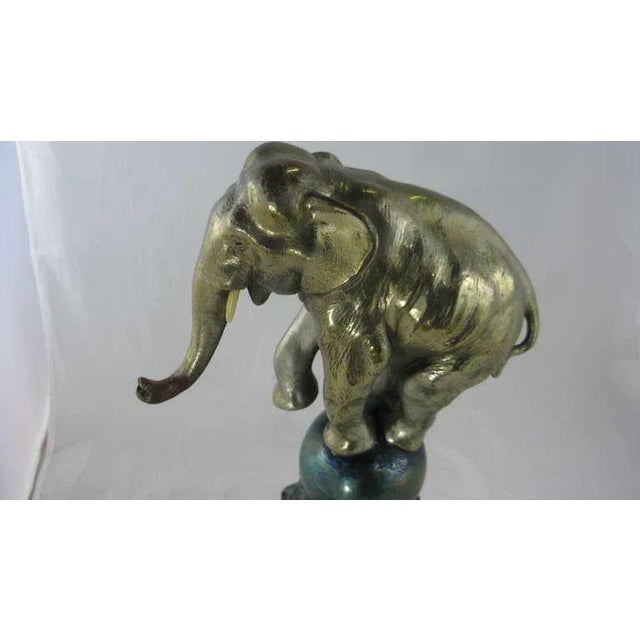 Art Deco whimsical silver plated bronze dancing elephant balancing on a blue glazed bronze ball and black patinated matte...