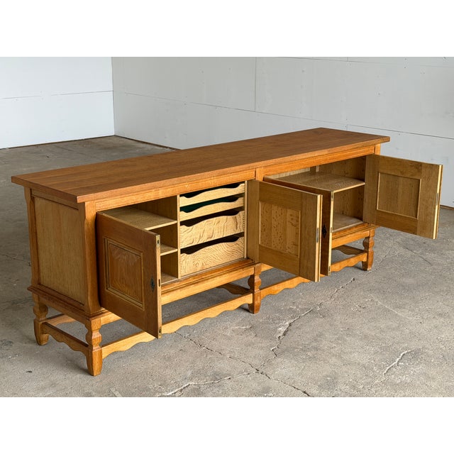 Danish Brutalist low sideboard designed by Henning Kjærnulf for Nyrup Møbelfabrik, Denmark, 1960s. Crafted in solid oak,...