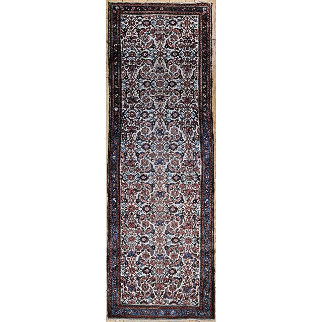 "An elegant and highly collectible example of early 20th-century village weaving, this Vintage Persian Malayer Runner...