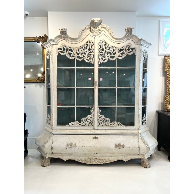 A stately Dutch Bombe buffet deux corps featuring a boldly contoured silhouette with serpentine lines, richly figured...