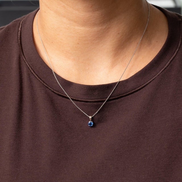 A 0.61ct kyanite round pendant set in solid 14K white gold. Kyanite is admired for a sapphire like blue that is still a...
