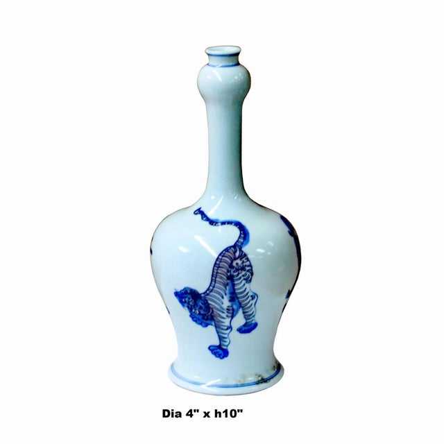 This is a handmade Chinese blue and white porcelain small vase. The surface is handpainted precise oriental Foo Dogs...
