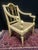 A striking pair of hand-painted hand french caned armchairs inspired by English Adam and Sheraton designs. Finished in...