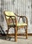 Add a tropical touch to your interior with this stunning vintage coastal bent rattan lounge chair. Featuring a beautifully...