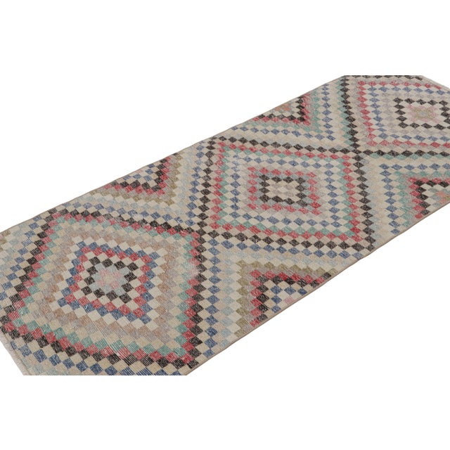 Handknotted in wool, this 3x6 vintage Art deco Zeki Múren rug originates from Turkey, circa 1960-1970 and is latest to...