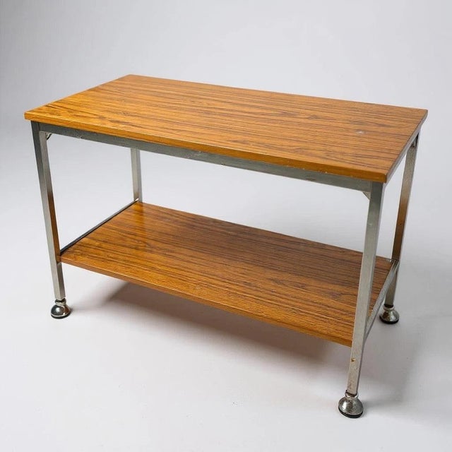 The Mid Century Drinks Trolley is a stylish portable bar furniture piece designed to elevate your entertaining experience...