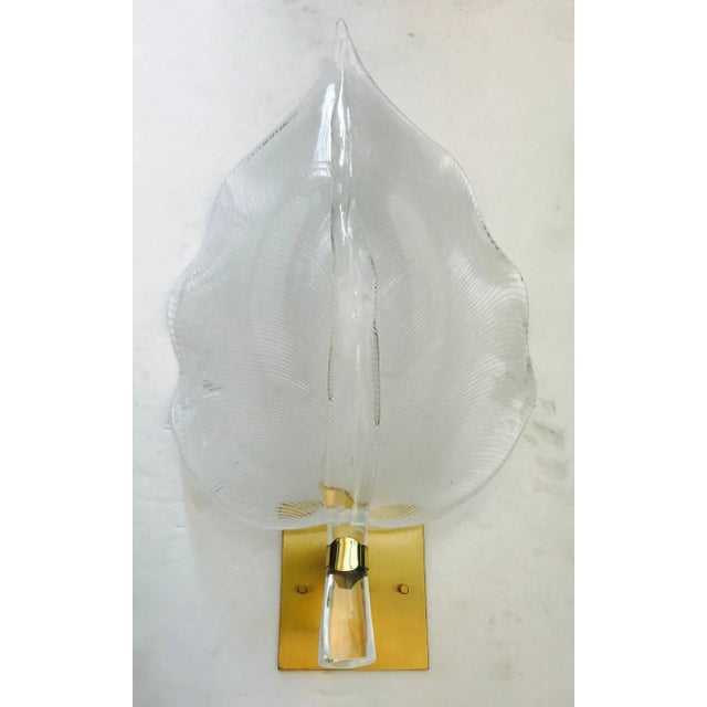 A beautiful pair of 1960s handblown clear and light white filigree Murano glass leaf sconces with brass fittings, newly...