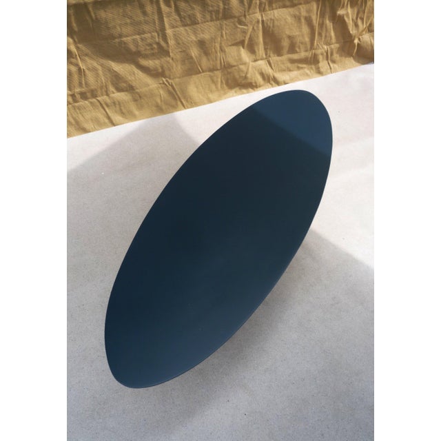 Oval coffee table Petrol blue lacquered MDF top, multicolored edges. Chrome-plated steel wire base.