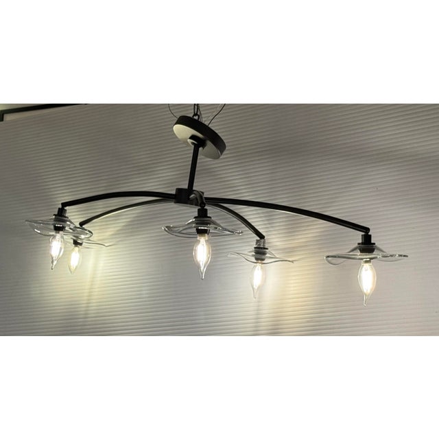 Design Plus Gallery presents the Lily Smoke Glass Chandelier from Restoration Hardware. This chandelier has a sculptural...