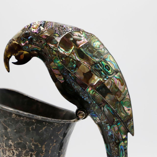 Circa 1960. We offer this Mexican metal and malachite pitcher sporting an amazing handle in a parrot motif by Los Castillo...