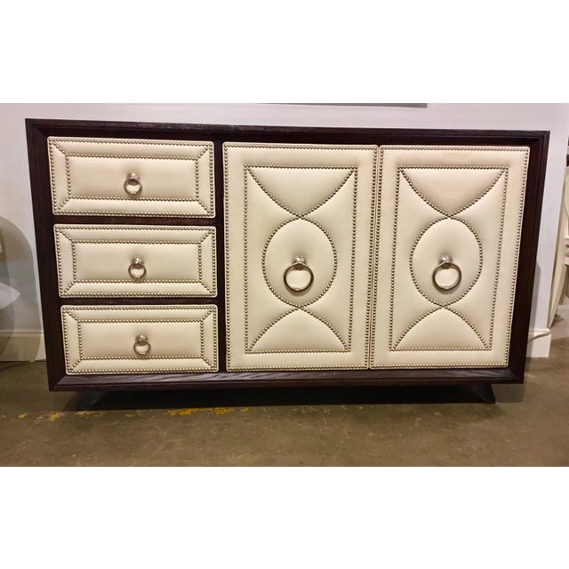 Original Retail $5100, stylish modern dresser with a dark walnut finished wood frame and top, white leather paneled door...
