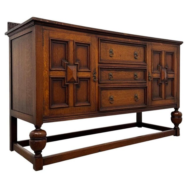 A fine and substantial early 20th-century English sideboard, constructed in oak and executed in the Jacobean style,...